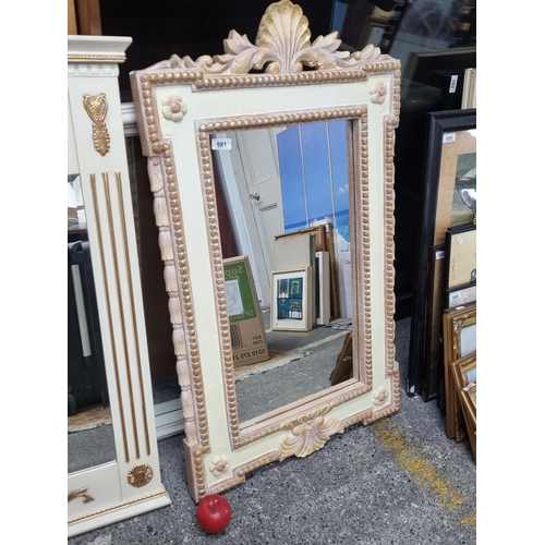 581 - A stylish cream and gilt molded frame mirror with beading.