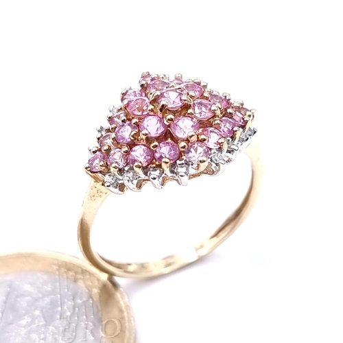 621 - Star Lot : A most attractive pink sapphire and diamond cluster ring set in 9K gold, size R, weight 3... 