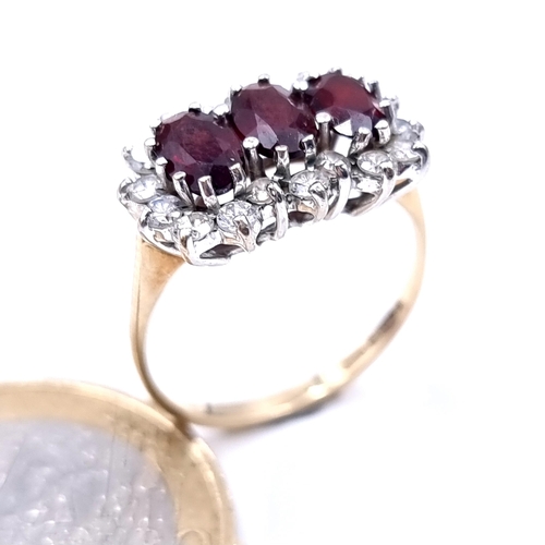 623 - Star Lot :  three stone garnet ring set in 9K gold with gem stone surround, ring size M, weight 2.46... 