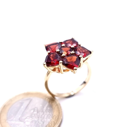 630 - Star Lot : A vintage 10K gold six stone garnet ring, ring size J 1/2, weight 3.53 grams.