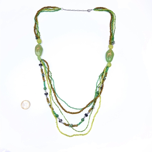 632 - An Asian multistrand necklace featuring jade scorpion design, length 74cm, weight 51 grams. Stones c... 