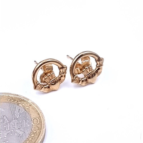 668 - A pair of 9K giold claddagh stud earrings, total weight 1.58 grams. Boxed.