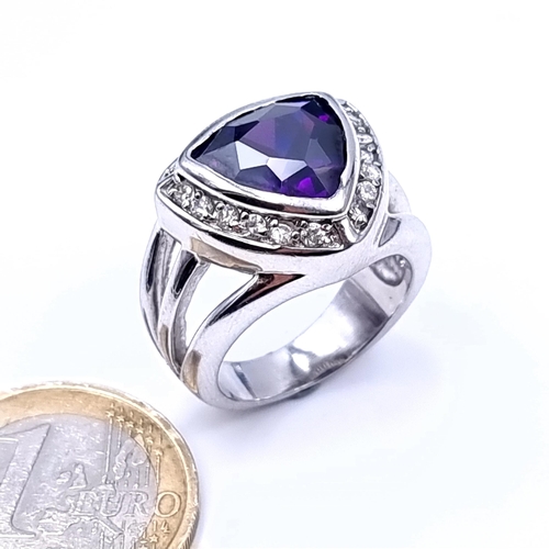 669 - A sterling silver amethyst stone ring with gem set surround, size Q, weight 10.7 grams, boxed.