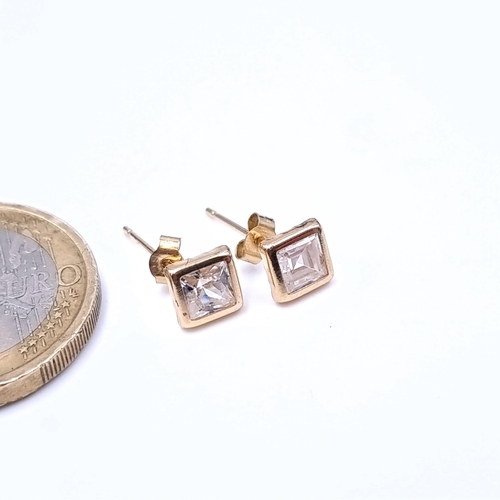 671 - A pair of 9K gold stud earrings set with gem stone mounts, boxed.