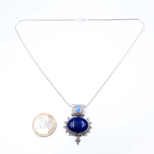 674 - A beautiful lapis lazuli cabochon and Moonstone pendant with silver chain, length 38cm.