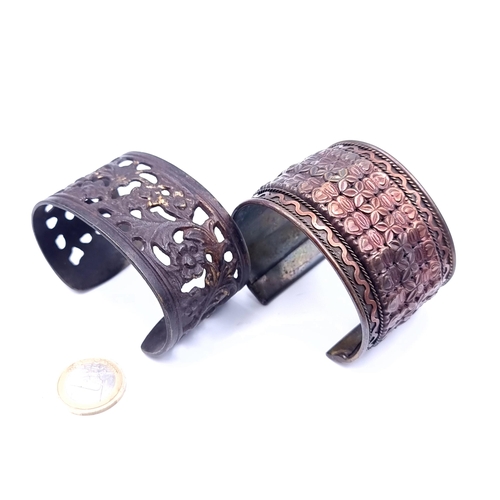 684 - Two nicely detailed Asian bangles, total weight 96 grams.