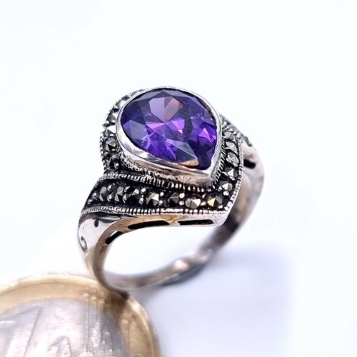 694 - A super art deco tear drop amethyst stone ring, mounted in marcasite and sterling silver, size O, we... 