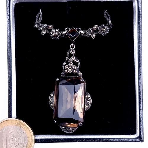 698 - An attractive vintage pendant necklace set with a smoky quartz stone with maracasite detailing, leng... 