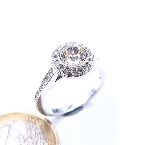 699 - A moissanite stone ring with cluster set Sterling Silver mount, ring size O, weight 3.77 grams.