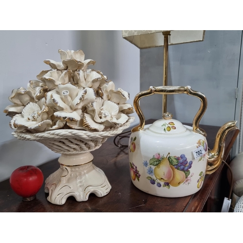 702 - Two highly ornate ceramic items including a heavy basket of roses and a teapot sculpture with floral... 