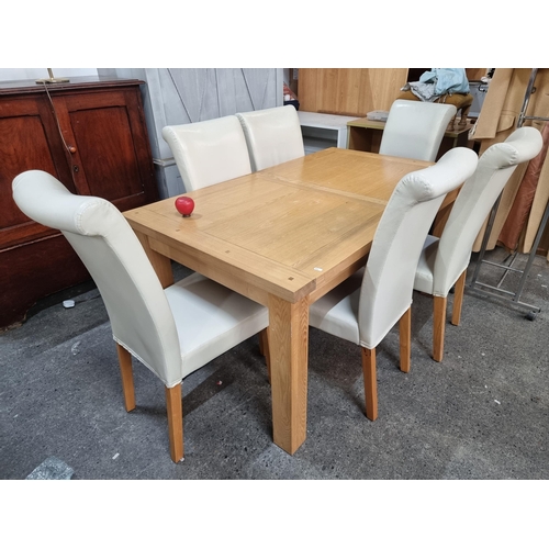 710 - A fabulous solid oak extendable dining table with six stylish dining chairs upholstered in a glossy ... 