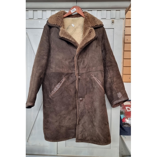 716 - A fantastic and very heavy shearling coat in a deep brown colour with two toned fur inside. To fit a... 