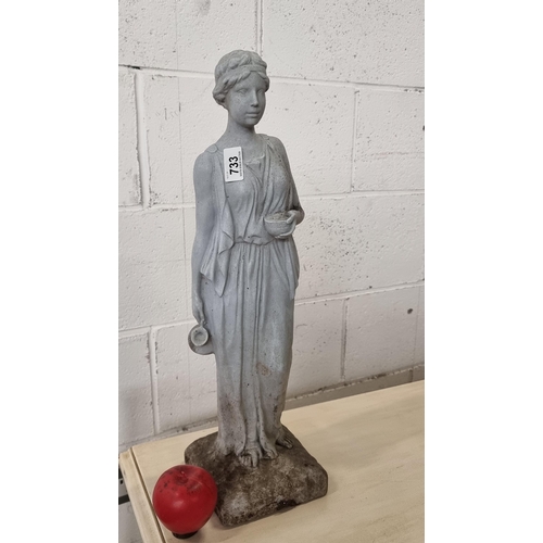 733 - Star Lot : A wonderful reconstituted stone garden sculpture of a Grecian goddess Hebe, holding her c... 