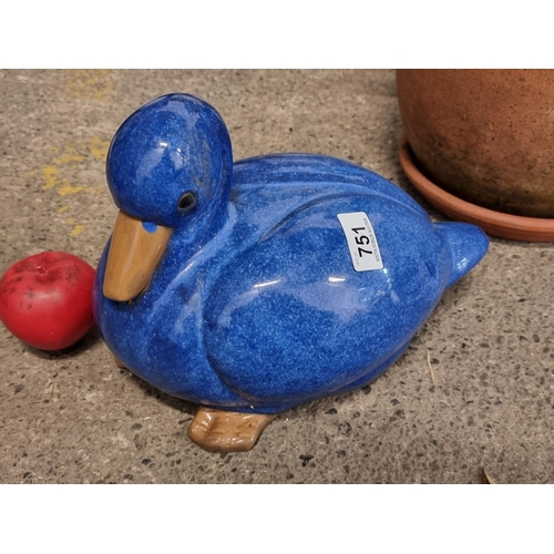 751 - A cheerful garden figure in the form of a duck in a vibrant blue glaze.