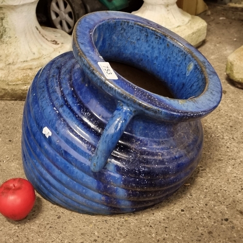 753 - An unusual planter in the form of a melting urn. Boasting attractive navy glaze.