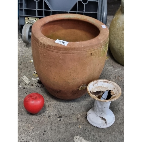 759 - A large terracotta planter with an attractive over hand rim.