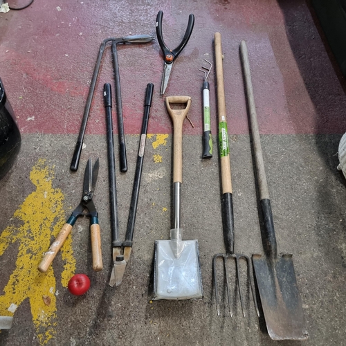 762 - A selection of 8 gardening tools including sheers, rakes and shovels.