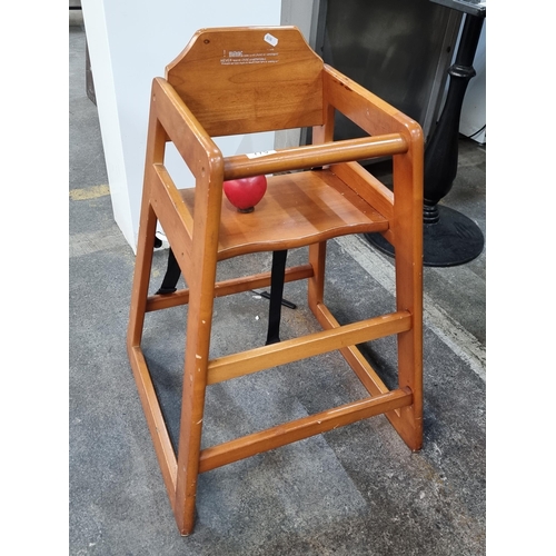 A good quality wooden children's high chair with steps. From a recently closed modern cafe.