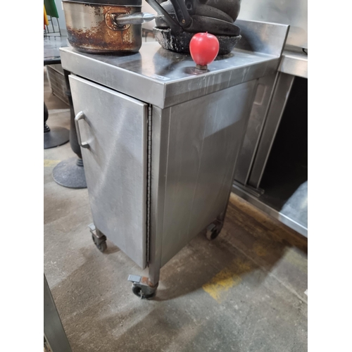 783 - A stainless steel commercial kitchen work station unit with gallery back, storage space and removabl... 