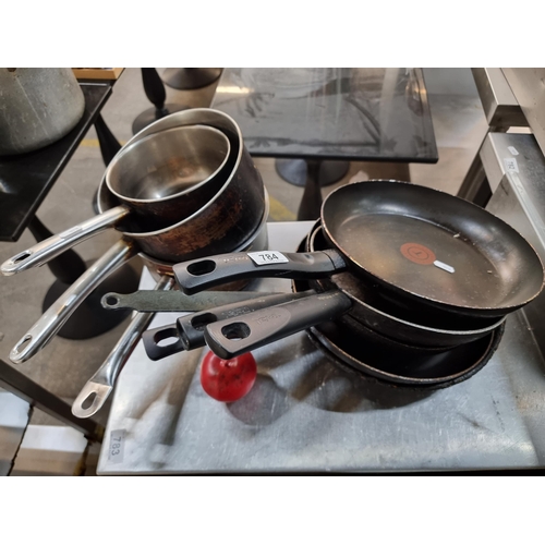 784 - Eight kitchen items including 4 Tefal pans along with pots. From a recently closed modern cafe.