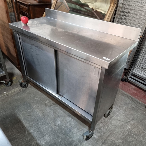 785 - A stainless steel commercial kitchen work station unit with Gallery back sliding doors revealing a s... 