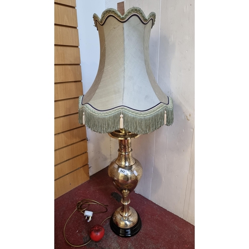 842 - Star Lot: A spectacular hand crafted table lamp boasting a stunning incised brass stem, profusely de... 