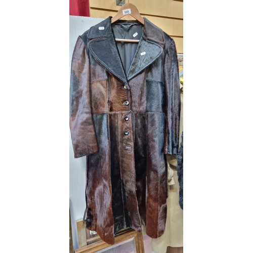 Star Lot: An incredible genuine fur coat with belt, four button fastening to front and two pockets. To fit a women's size 10-12. Fur in very good condition.