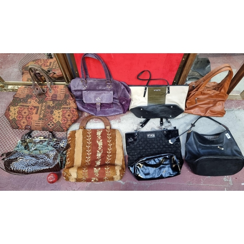 850 - An eclectic collection of vintage ladies bags including some branded examples such as Bessie, Nine W... 