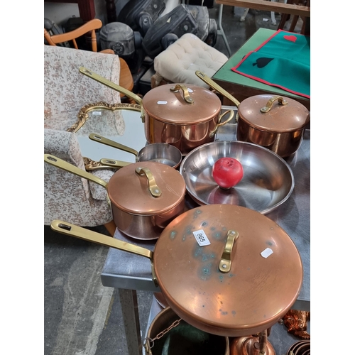 865 - A collection of 6 copper and brass cooking pots in varying sizes.