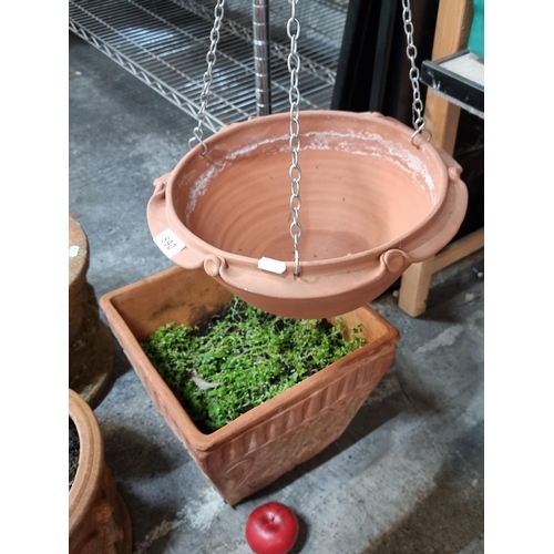 890 - Two garden items consisting of a terracotta hanging basket along with a large square terracotta plan... 