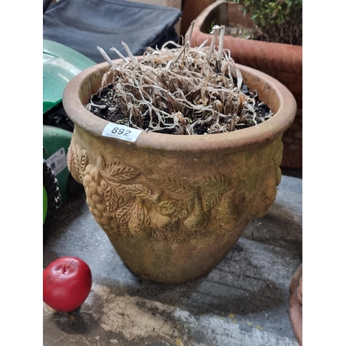 892 - A large heavy circular terracotta planter featuring a wonderful grapevine motif.