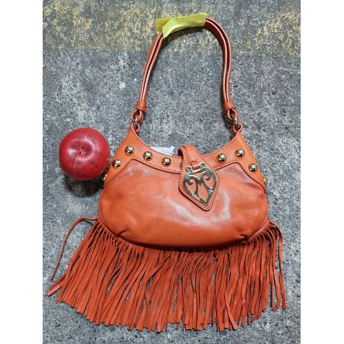 904 - A fabulous shoulder bag in a vibrant orange finish. By 'Moschino'. Finished with fringe and brass st... 