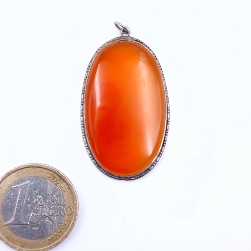 656 - A pretty carnelian stone pendant with a sterling silver mount collar, 4.5cm x 2.5cm.