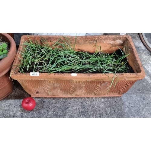 886 - A nice terracotta trough planter with a tactile finish.