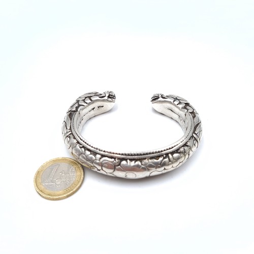 8 - A heavy silver Asian torc bracelet with snake head, weight 136.8 grams.