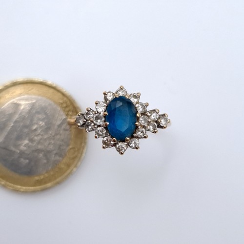 615 - An attractive diamond and central blue topaz stone ring mounted in 9K gold (375), ring size N, weigh... 