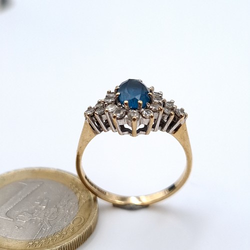 615 - An attractive diamond and central blue topaz stone ring mounted in 9K gold (375), ring size N, weigh... 