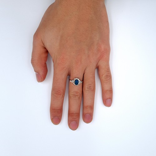 615 - An attractive diamond and central blue topaz stone ring mounted in 9K gold (375), ring size N, weigh... 