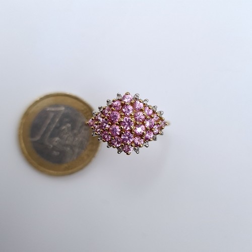 621 - Star Lot : A most attractive pink sapphire and diamond cluster ring set in 9K gold, size R, weight 3... 