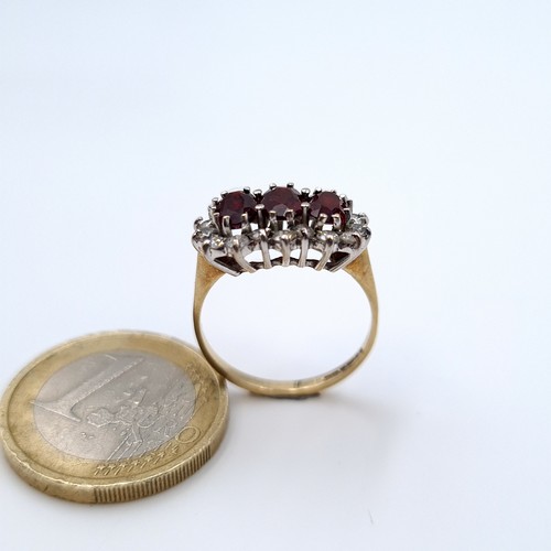 623 - Star Lot :  three stone garnet ring set in 9K gold with gem stone surround, ring size M, weight 2.46... 