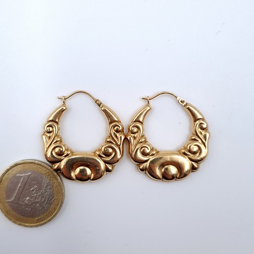 624 - A pair of attractively designed 9K gold hoop earrings, suitable for pierced ears, marked 375 to post... 