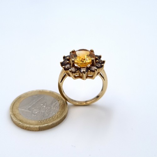 625 - Star lot : A nice example of a heavy Gold citrine stone ring with smoky quartz stone surround mounte... 