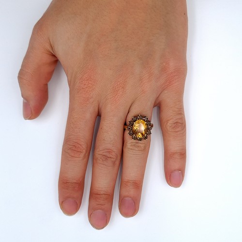 625 - Star lot : A nice example of a heavy Gold citrine stone ring with smoky quartz stone surround mounte... 