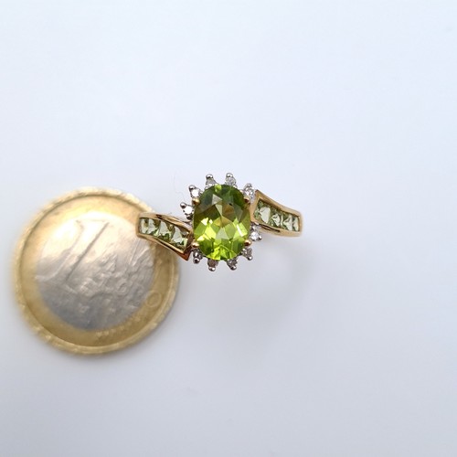 627 - Star lot : A nice example of a 9K gold peridot stone ring with twist diamond set mount, ring size O,... 