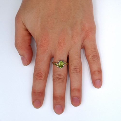 627 - Star lot : A nice example of a 9K gold peridot stone ring with twist diamond set mount, ring size O,... 