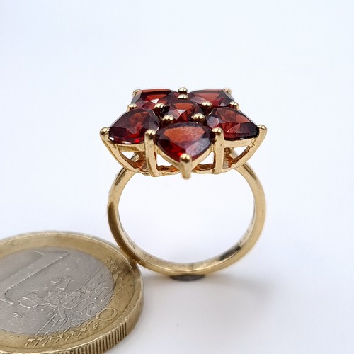 630 - Star Lot : A vintage 10K gold six stone garnet ring, ring size J 1/2, weight 3.53 grams.