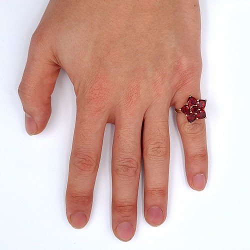 630 - Star Lot : A vintage 10K gold six stone garnet ring, ring size J 1/2, weight 3.53 grams.