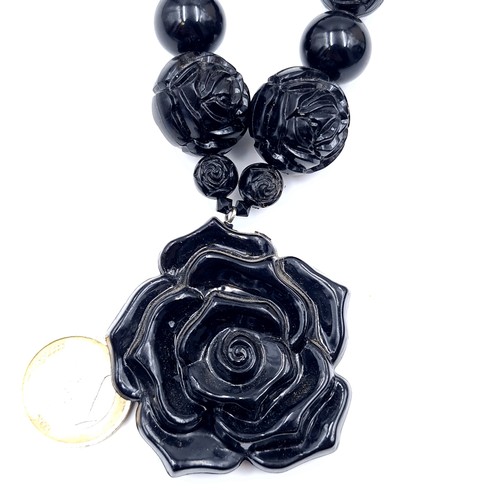 634 - An attractive example of an art deco graduated rose design Jett mourning pendant necklace, length 86... 