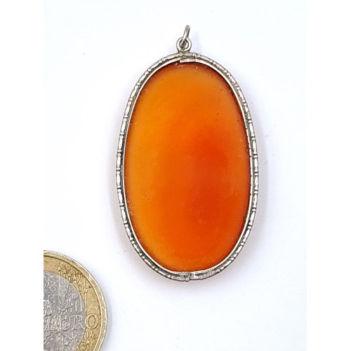 656 - A pretty carnelian stone pendant with a sterling silver mount collar, 4.5cm x 2.5cm.