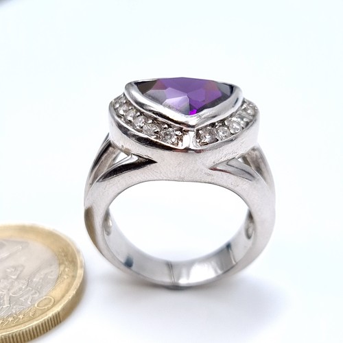 669 - A sterling silver amethyst stone ring with gem set surround, size Q, weight 10.7 grams, boxed.